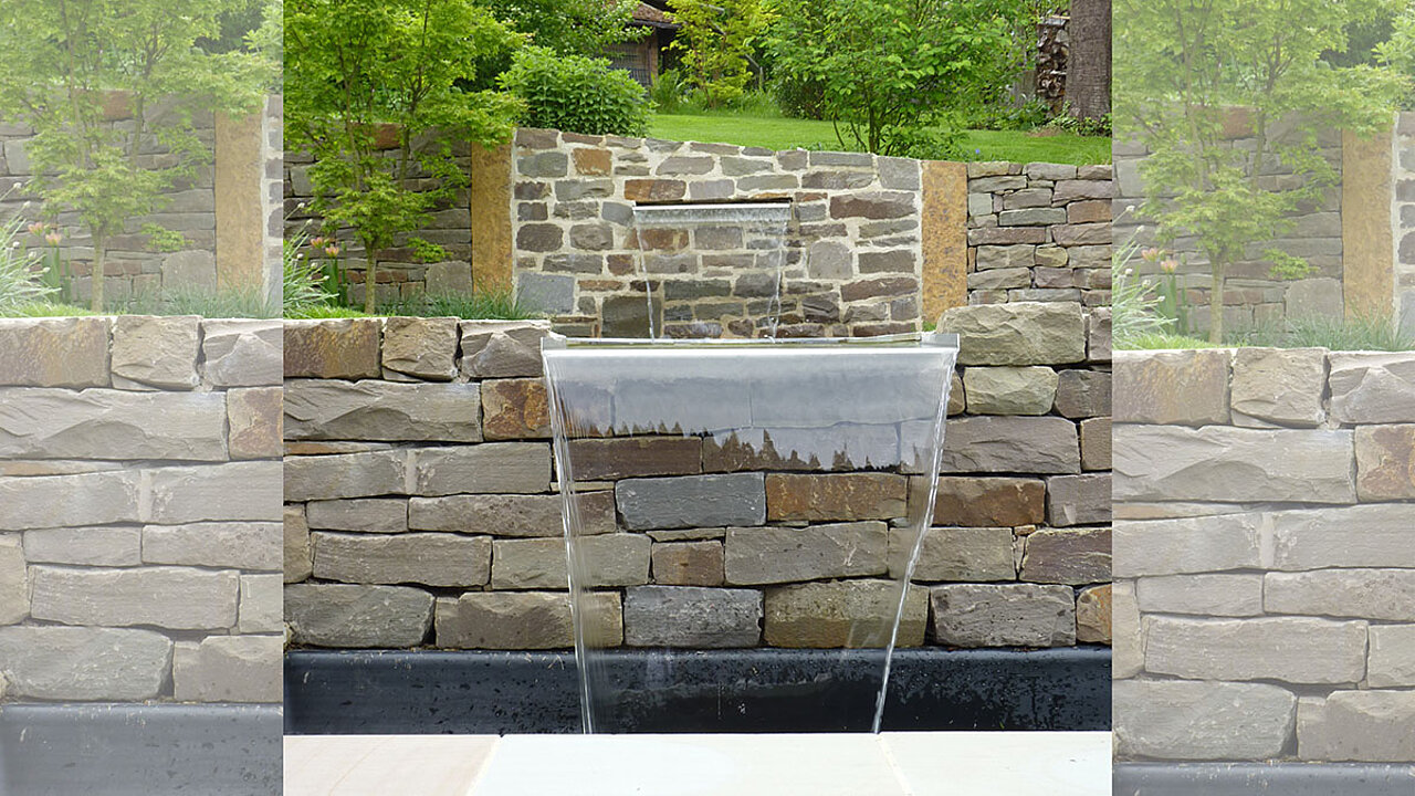 Hanggestaltung - Natursteinmauer mit Wasserfall